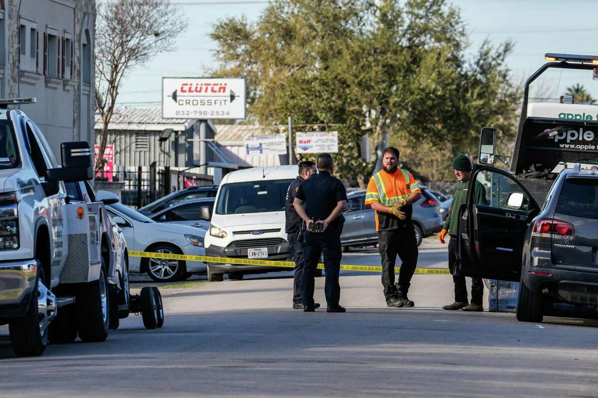 Harris County Police officer, Sgt.Pham, speaks to tow truck drivers at the scene where an off-duty Harris County Sheriff’s Office deputy and another man were shot at Liquid Lounge on Monday, Dec. 26, 2022 in Houston.