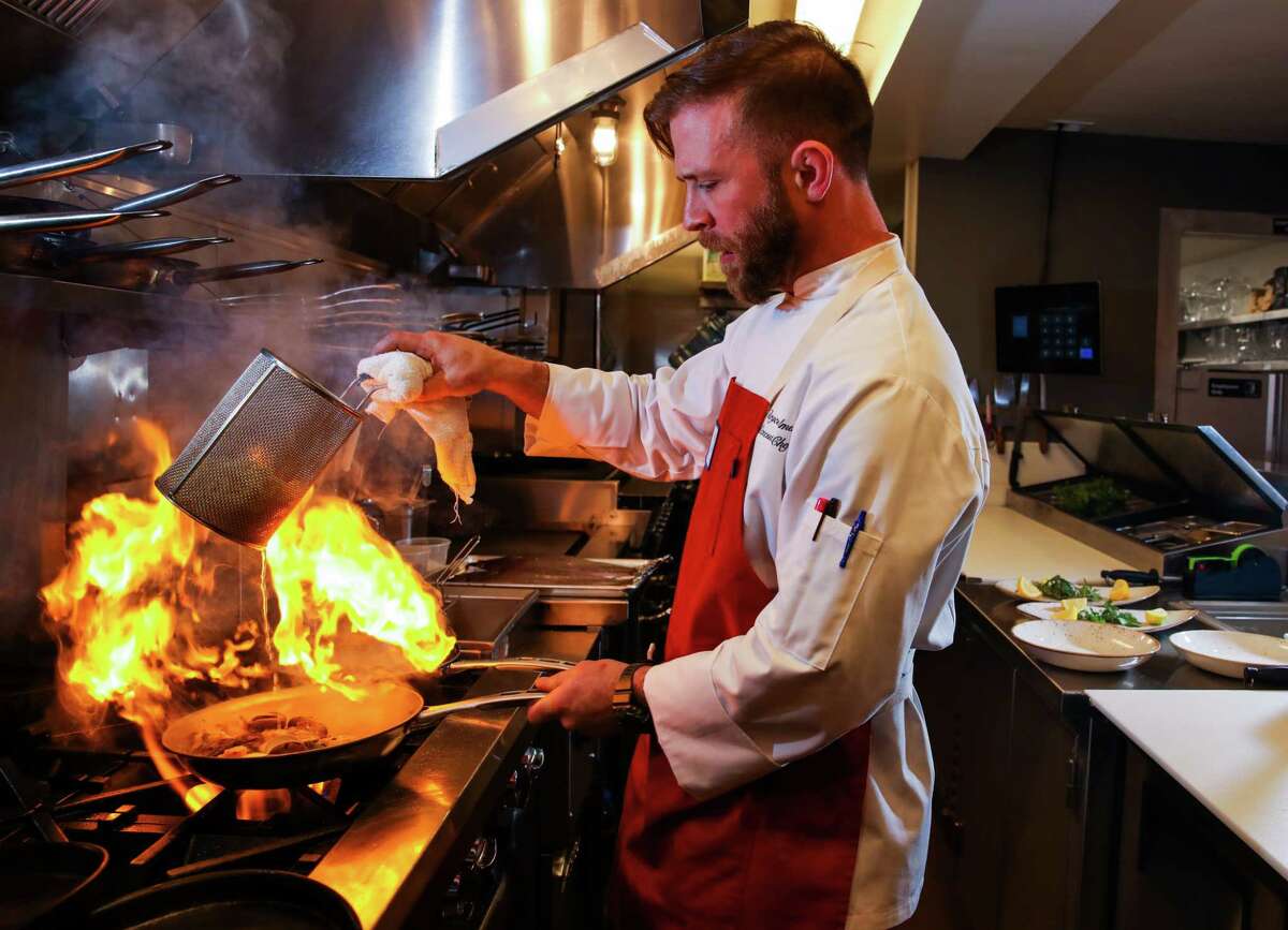 Executive chef Bryce Palmer cooks a seafood pasta dish at Scala Osteria.
