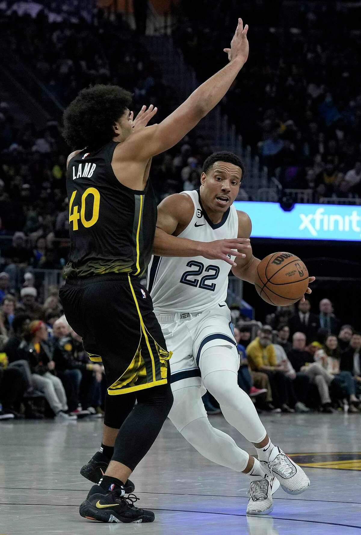 SAN FRANCISCO, CALIFORNIA - DECEMBER 25: Desmond Bane #22 of the Memphis Grizzlies drives and gets fouled by Anthony Lamb #40 of the Golden State Warriors during the third quarter at Chase Center on December 25, 2022 in San Francisco, California. NOTE TO USER: User expressly acknowledges and agrees that, by downloading and or using this photograph, User is consenting to the terms and conditions of the Getty Images License Agreement. (Photo by Thearon W. Henderson/Getty Images)
