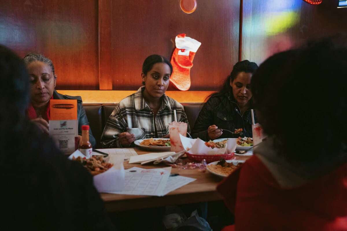 Selam Aklilu eats dinner with her family during the Willie Mays Scholar Program's social mixer at Underdogs Cantina on Tuesday night, December 18, 2022.