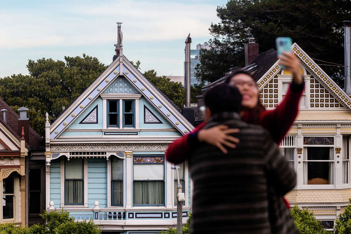 Tourists snap a selfie in front the Painted Ladies. San Francisco is home to many Victorians, including the pastel-colored homes on Steiner Street.
