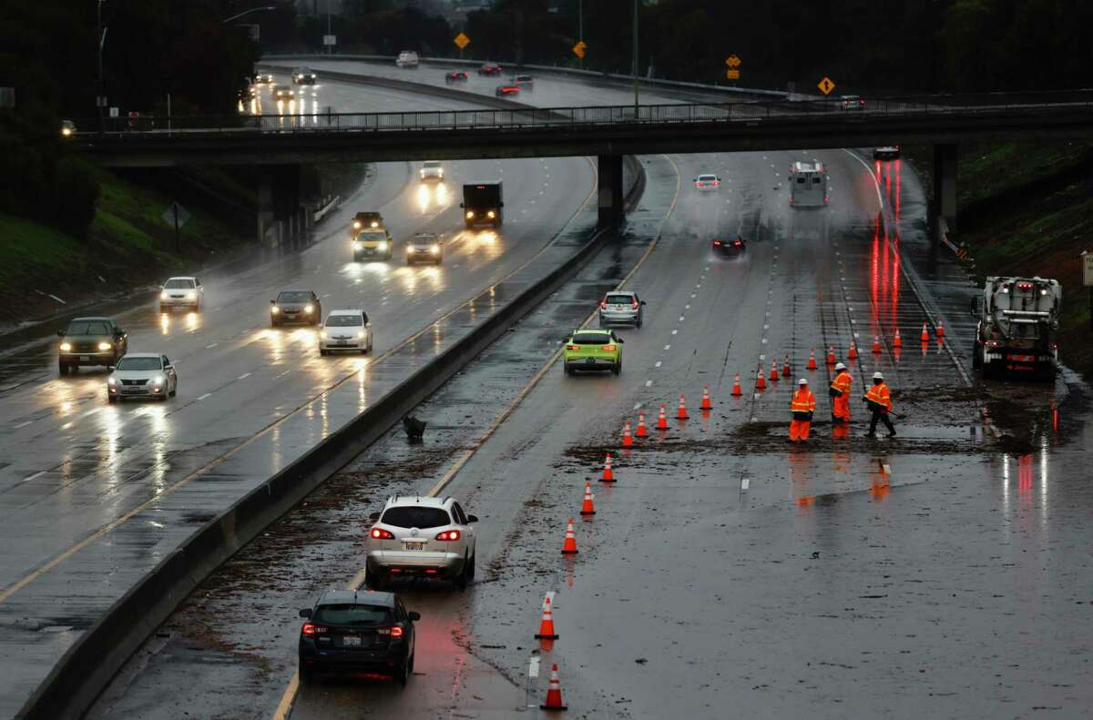 The three right lanes of traffic on westbound Interstate 580 near 35th Avenue are blocked while crews try to clear the roadway of major flooding as a strong atmospheric river unleashes torrential rain over Oakland.