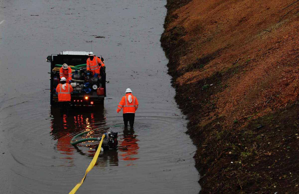 Crews try to clear major flooding on westbound Interstate 580 near 35th Avenue in Oakland.