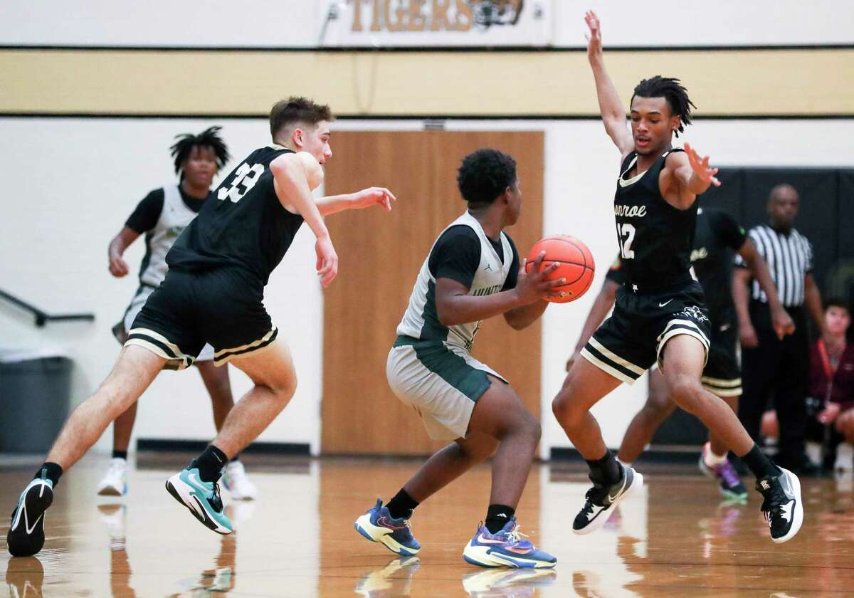 Conroe's Nigel Leday (12) pressures a Huntsville player during a high school basketball game at the Conroe Christmas Classic at Conroe High School, Tuesday, Dec. 27, 2022, in Conroe.