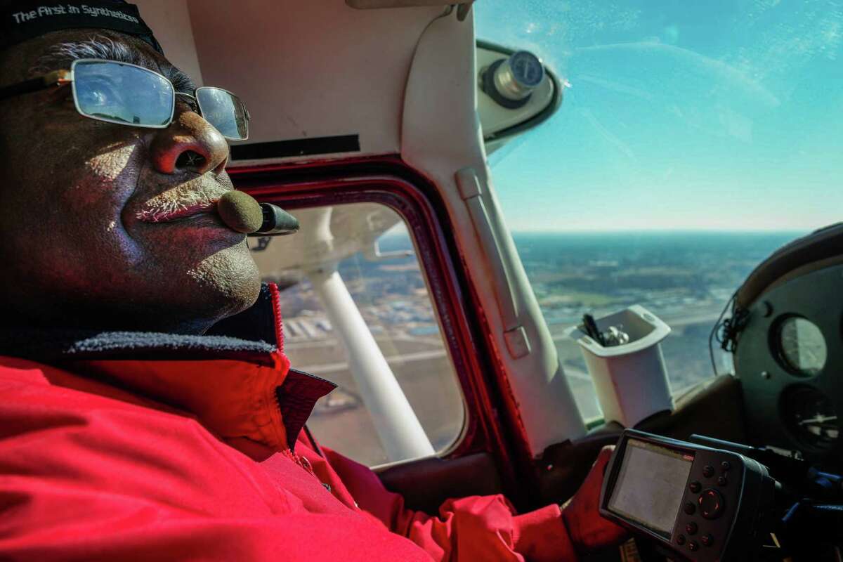 Veteran, John Dyer looks out of the window of his plane on Tuesday, Dec. 27, 2022 at David Wayne Hooks Memorial Airport in Houston. John Dyer was awarded the Wright Brothers award by the FAA for fifty years of flying safety.