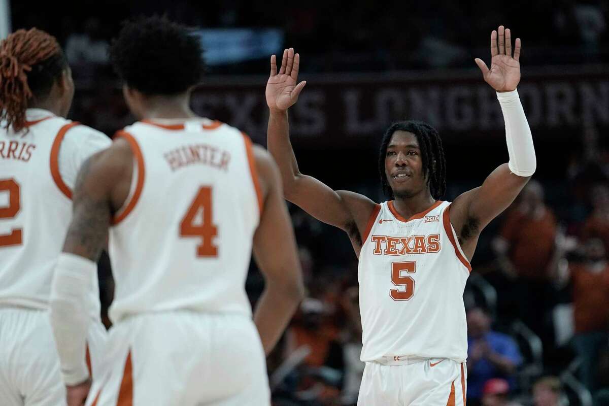 Texas guard Marcus Carr (5) celebrates a score with teammates during the second half of an NCAA college basketball game against Texas A&M-Commerce in Austin, Texas, Tuesday, Dec. 27, 2022.