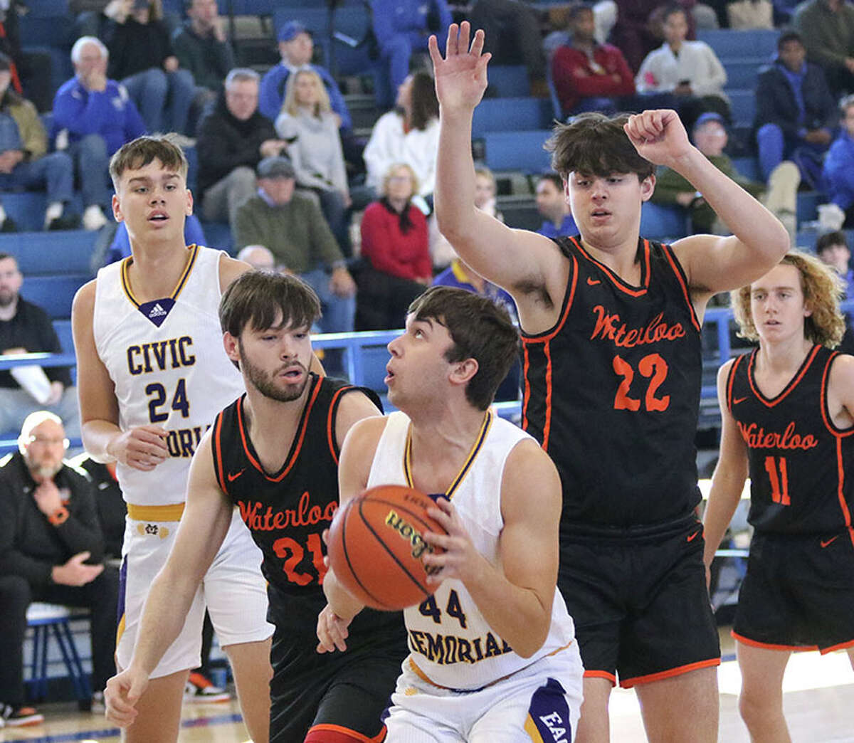 CM's Dalton Buhs (44) looks to shoot while Waterloo's Wyatt Fink (21) and Alex Stell (22) defend in the lane Tuesday at the Freeburg-Columbia Holiday Tournament in Freeburg. CM's Sam Buckley (left) and Waterloo's Isaac Lohman (right) watch the play.