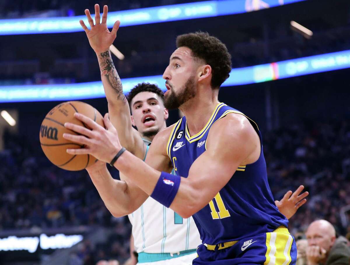Golden State Warriors’ Klay Thompson shoots against Charlotte Hornets’ LaMelo Ball in 1st quarter during NBA game at Chase Center in San Francisco, Calif., on Tuesday, December 27, 2022.