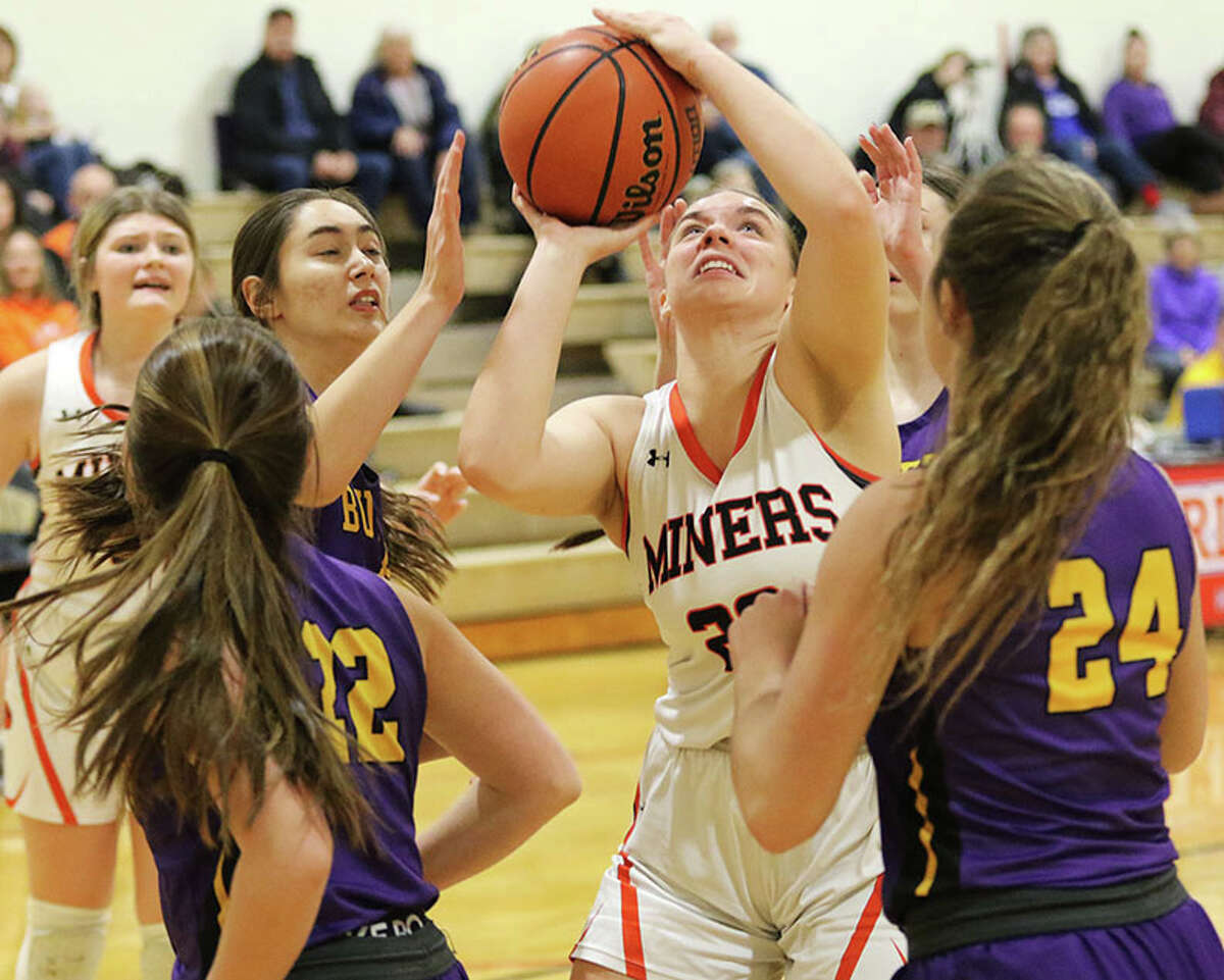 Gillespie's Emily Schoen (middle) shown putting up a shot against three Bullets from Williamsville on Monday, scored 12 points in the Miners' win over Raymond Lincolnwood on Tuesday.