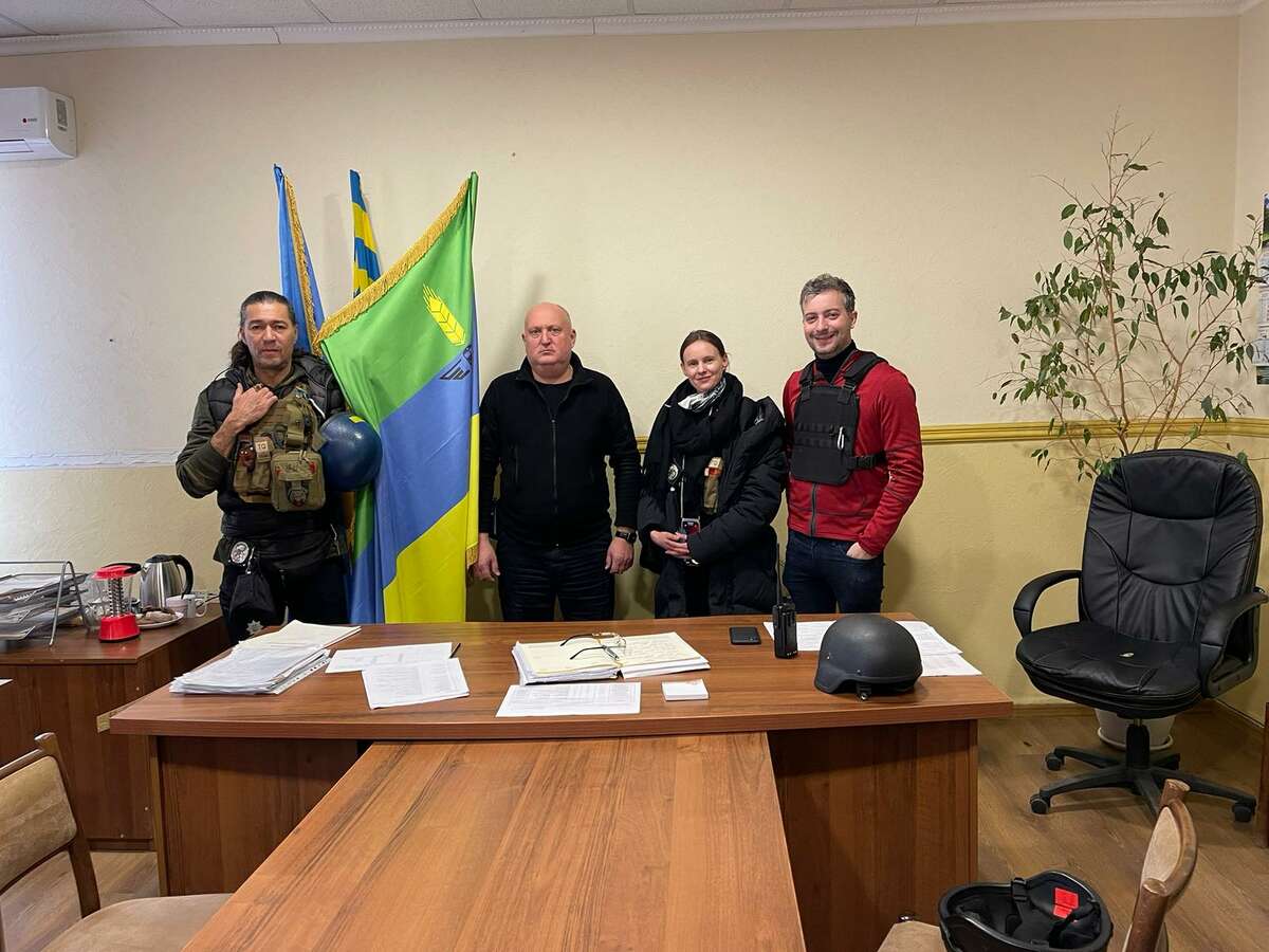 (L to R) Richard von Groeling of Alex21, Mayor of Lymon Oleksandr Zhuravlov, Liz Olegov of Alex21 and Brian Mayer of UAI in an office in Ukraine. 