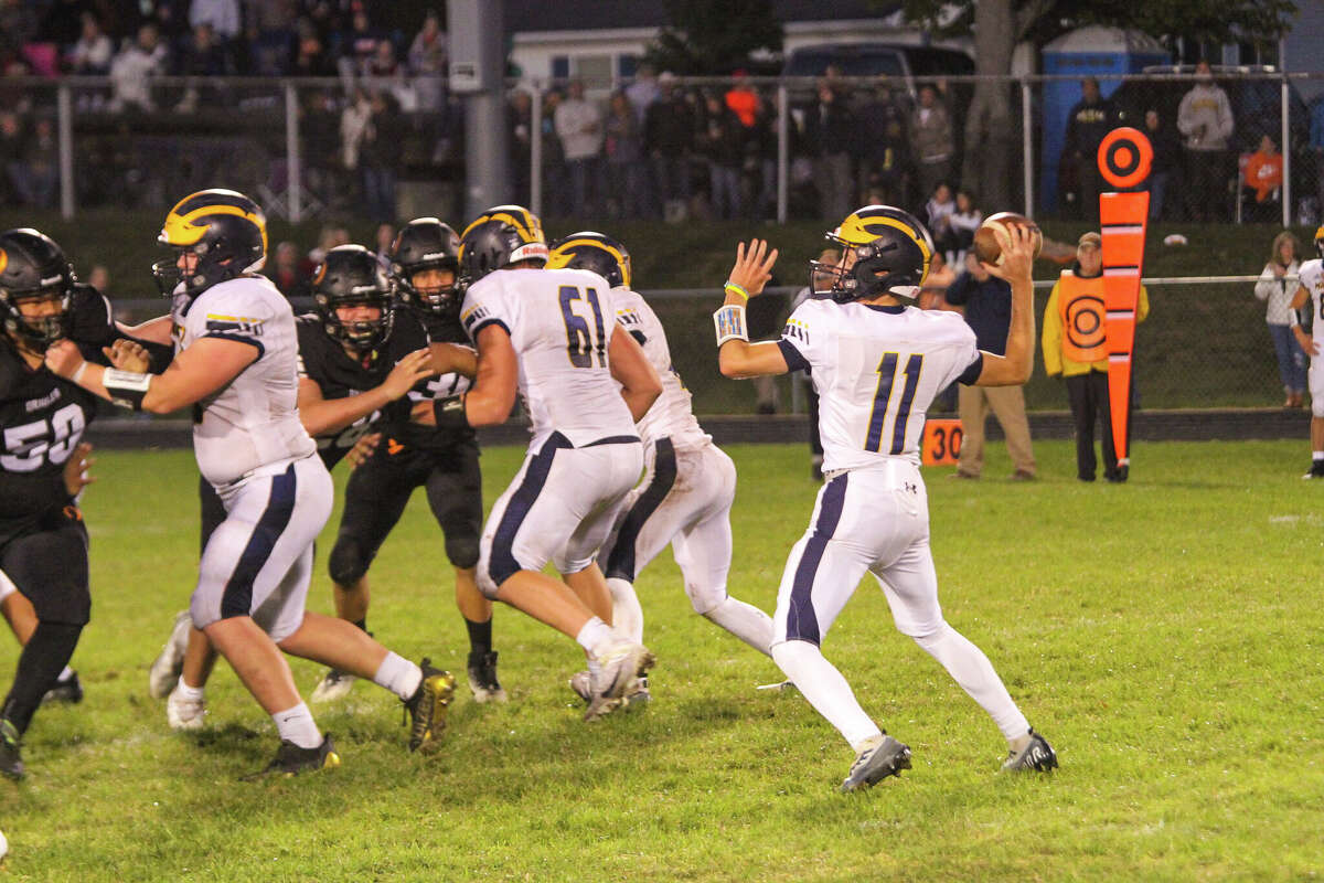 Manistee quarterback Jeff Huber drops back to pass against Ludington during the 2022 season. 