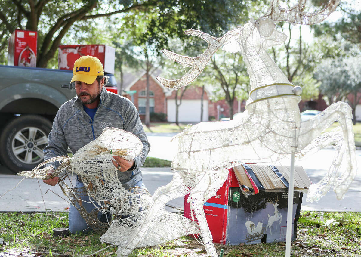 Michael Oquinn disassembles reindeer holiday decorations in front of his home, Wednesday, Dec. 28, 2022, in Kingwood. â[Taking Christmas decorations down] is the worse part, but at least Iâve got great weather to do it in,â Oquinn said of the 70-degree weather. âBetter than what we had the last few days.â
