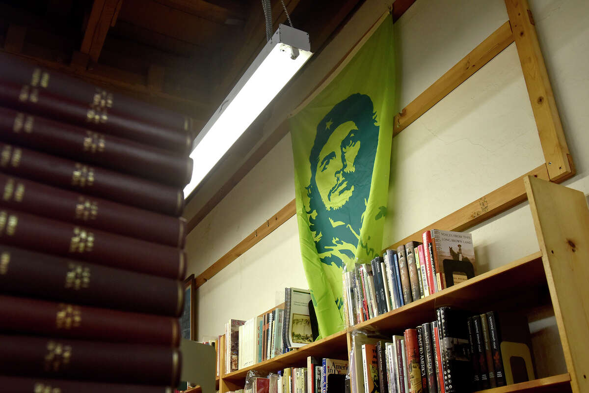 A Che Guevara flag hangs over one of the many bookshelves inside Bolerium Books, at 2141 Mission St., San Francisco. 