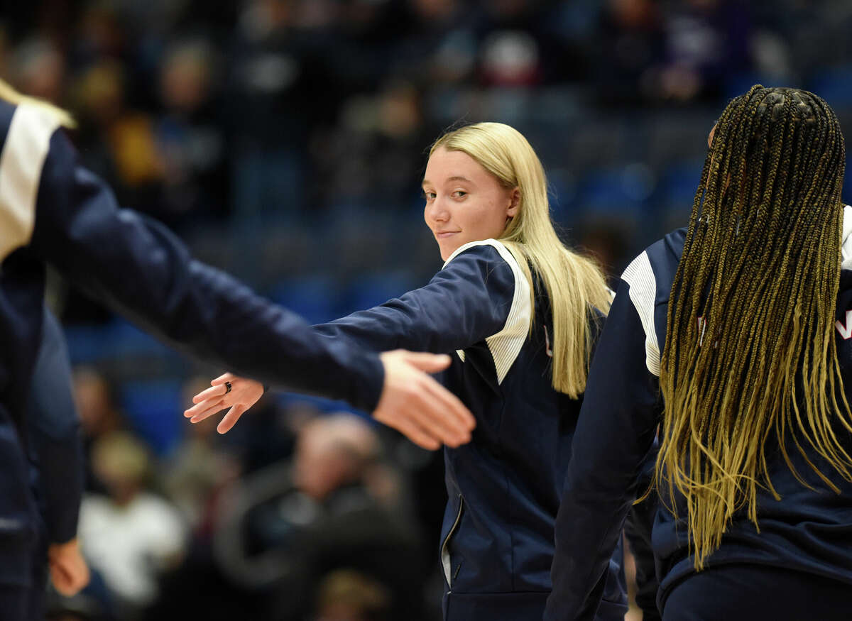 High-fiving a teammate before the No. 5 UConn wins No. 10 North Carolina State University 91-69 during an NCAA women's college basketball game at the XL Center in Hartford, Connecticut, November 20, 2022. Paige Bookers of the UConn guard.