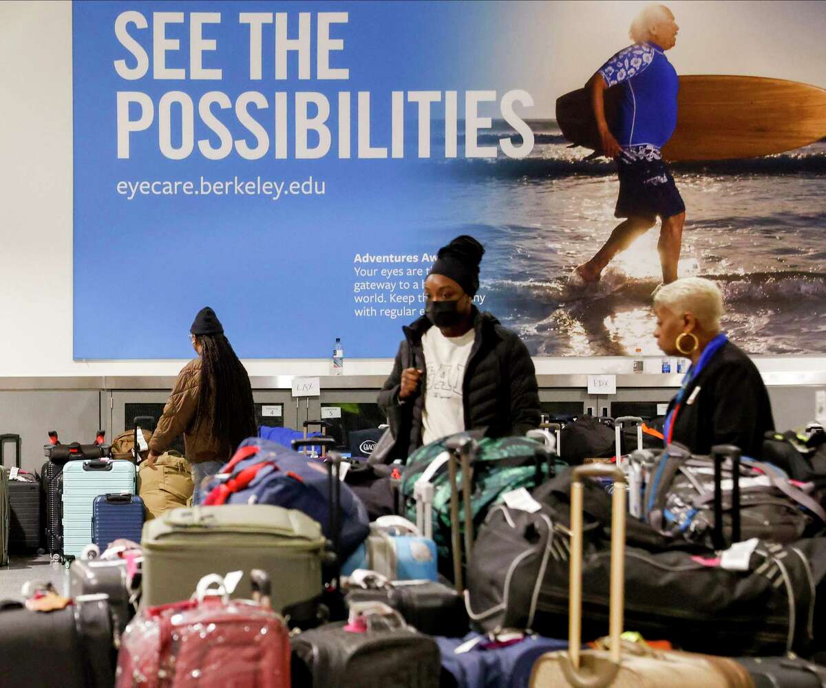 Airport employees sorted through a barrage of luggage that arrived at Oakland International Airport while their owners were stranded somewhere else amid the Southwest Airlines chaos.