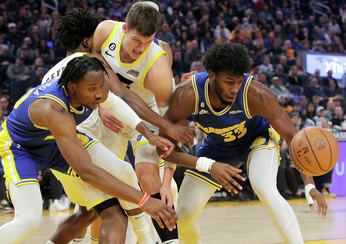 James Wiseman (33) reaches for a loose ball in the first half as the Golden State Warriors played the Utah Jazz at Chase Center in San Francisco, Calif., on Wednesday, December 28, 2022.