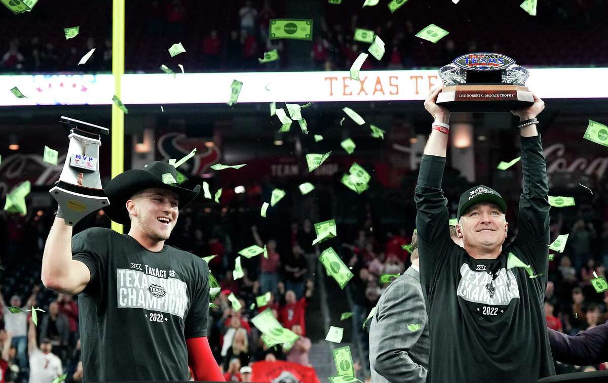 Texas Tech Red Raiders quarterback Tyler Shough (12) and Texas Tech Red Raiders head coach Joey McGuire holds up trophies after their team defeated Mississippi Rebels 42-25 in the TaxAct Texas Bowl at NRG Stadium on Thursday, Dec. 29, 2022 in Houston.