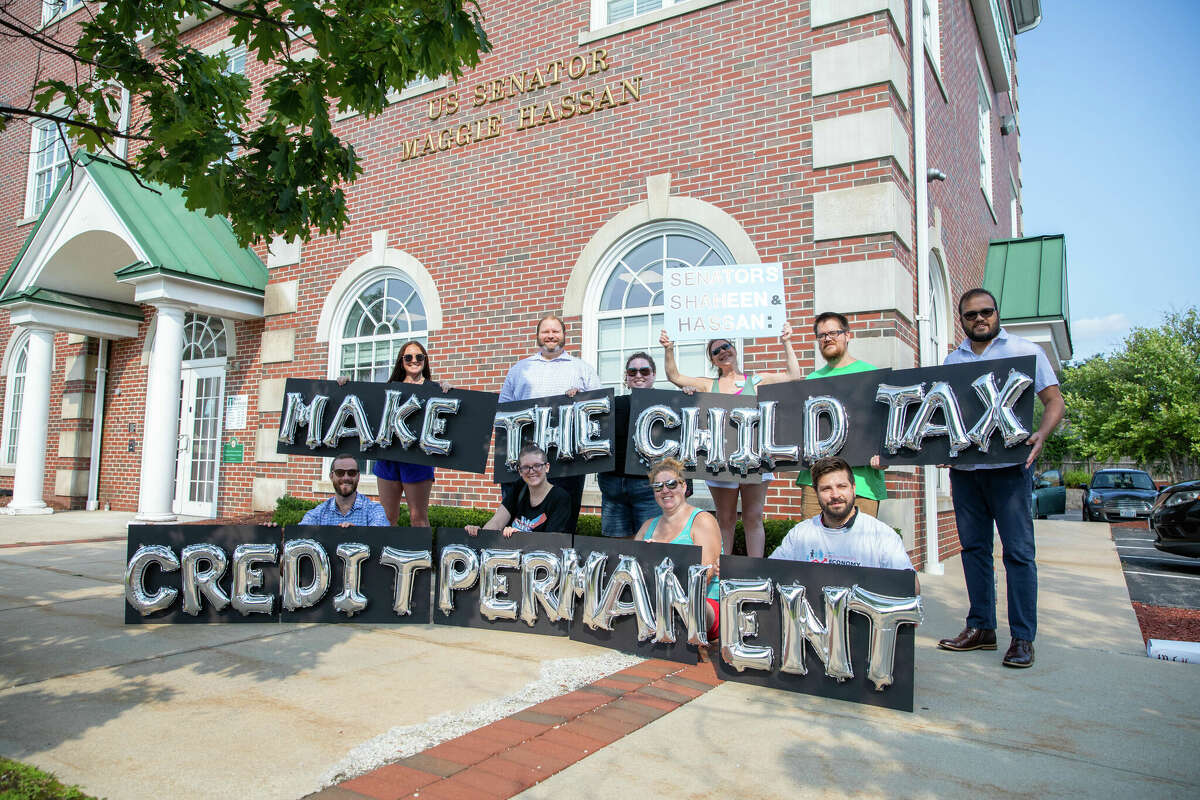 New Hampshire parents and other supporters gather outside of Sen. Hassan's Manchester office to thank her for child tax credit payments and demand they be made permanent on Sept. 14, 2021 in Manchester, New Hampshire. 
