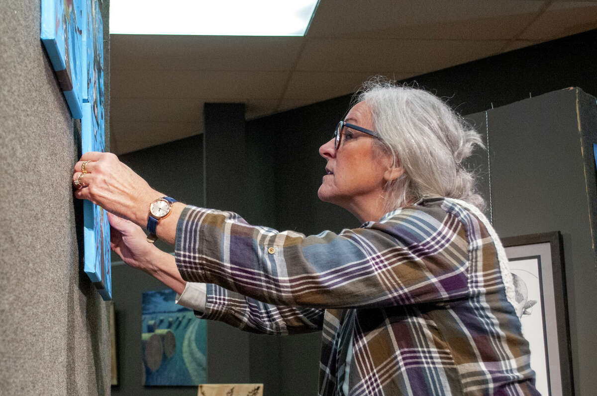 Ruth Vermeer places art for display at Artworks in Big Rapids ahead of a show that opens Jan. 03 and runs through Jan. 28. The exhibit, called "Discovering Traditions: Hope Network and MoCi; Seven Years of Artworks" can been seen in the Batdorff gallery, 106 N. Michigan Ave. A reception for the public will be 5 p.m. Jan. 12.
