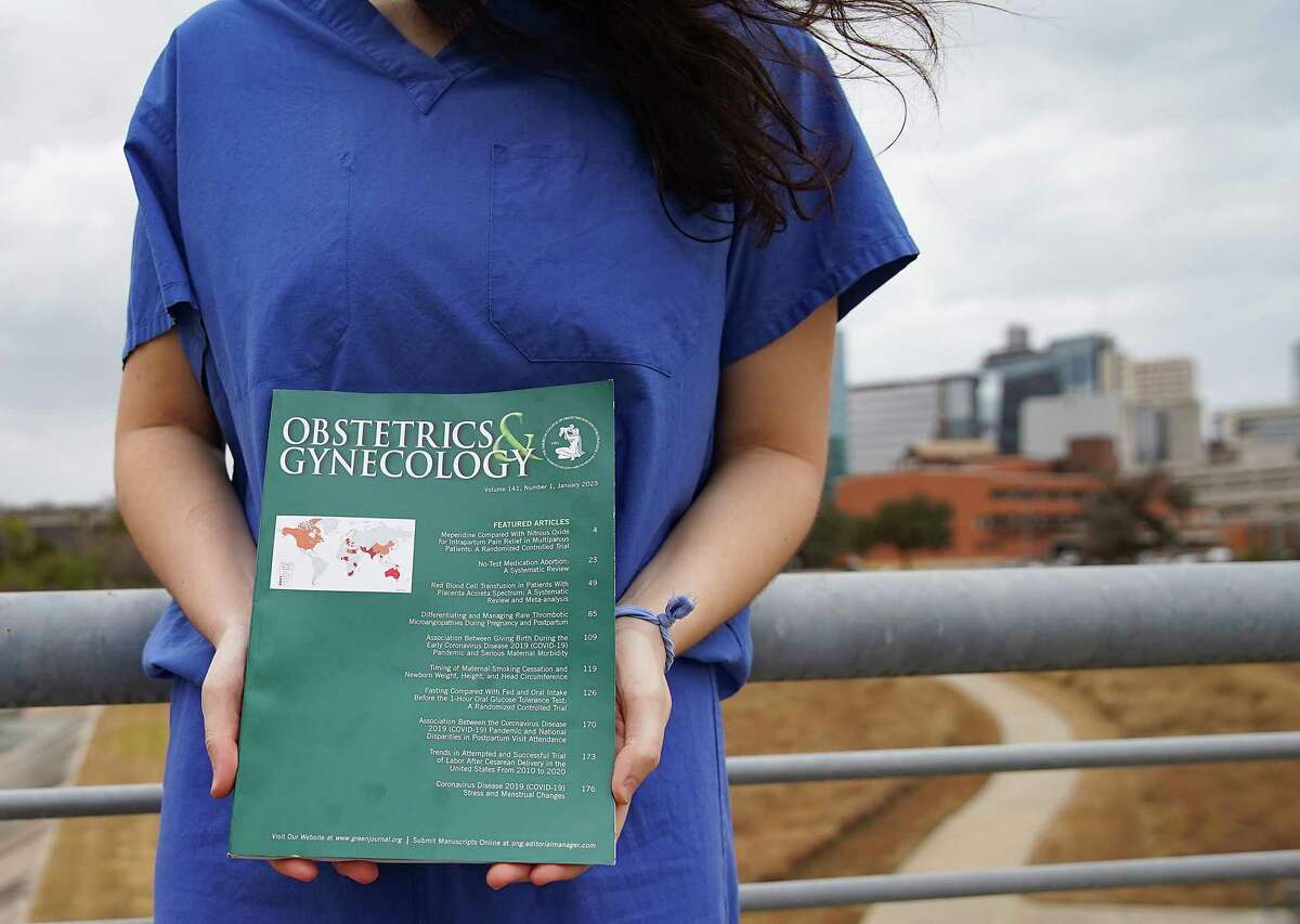 A former Houston medical student who is training in Pennsylvania, holds “The Green Journal”, an OBGYN trade publication on Thursday, Dec. 29, 2022 in Houston. With the stricter abortion laws, she’s not sure she wants to return to Houston to continue her career.