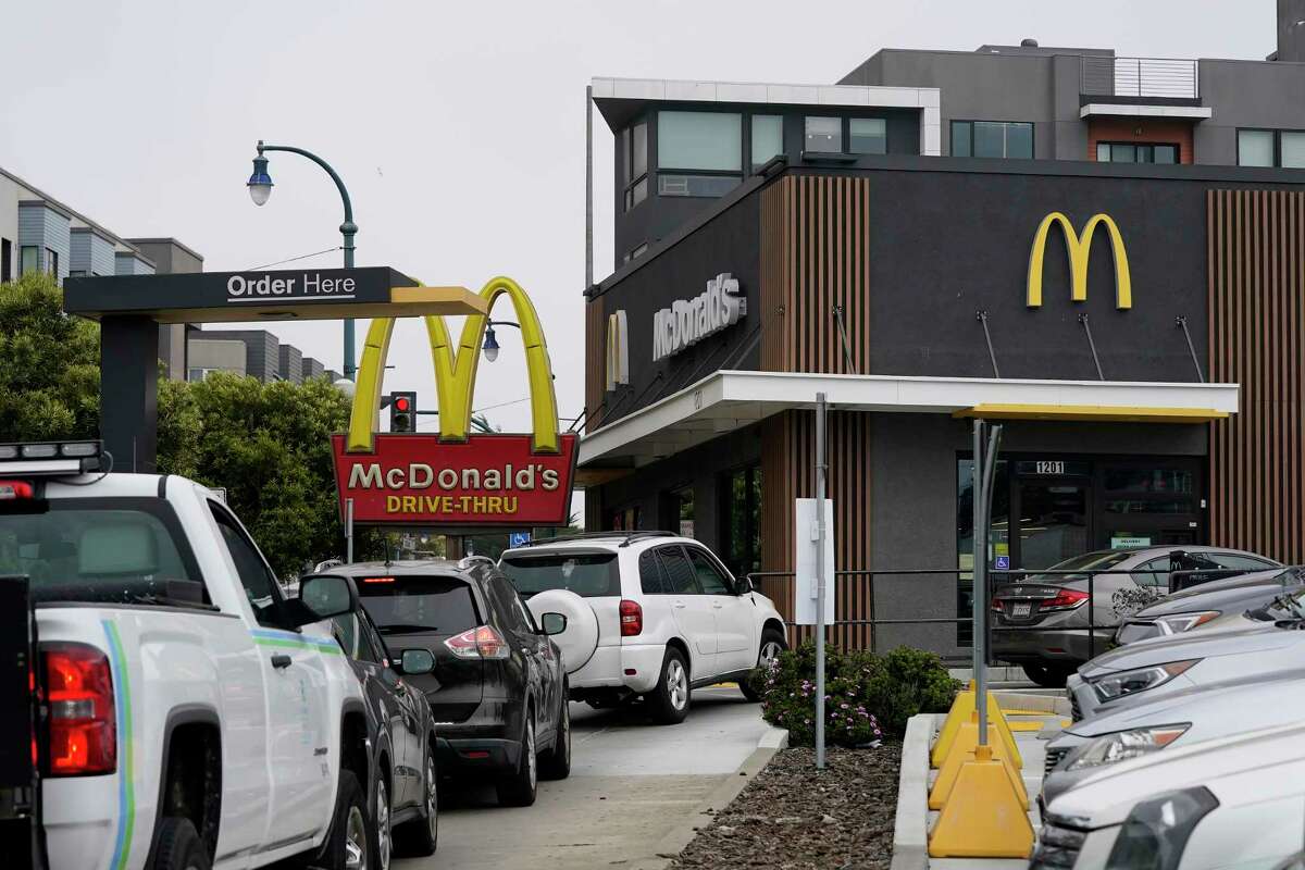 Cars wait in the drive-thru line at a McDonald's restaurant in San Francisco on Thursday, Aug. 25, 2022. A landmark law set to provide more protections to fast food restaurant workers is due to take effect on Jan. 1, but opponents gathering signatures for a ballot initiative have filed a lawsuit to halt its implementation.  (AP Photo/Jeff Chiu, File)