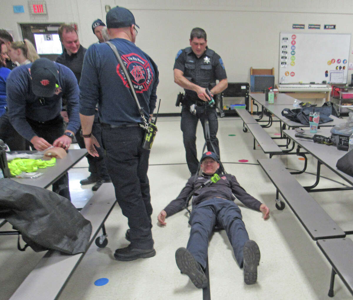 Members of the Collinsville Police Department and the Collinsville Fire Department practice how to carry and rescue a victim during an active shooter training session Thursday at Summit Elementary School in Collinsville.
