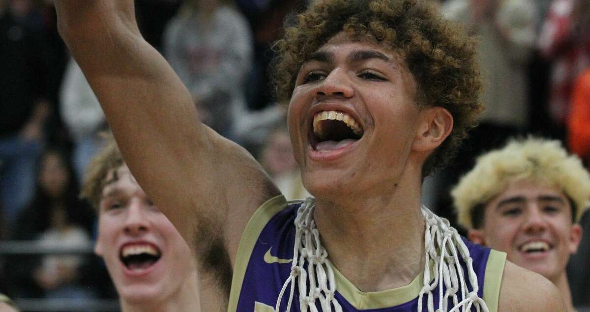 Routt's Michael Wilson and teammates celebrate after beating New Berlin in overtime to win the Waverly Holiday Tournament championship Thursday night.