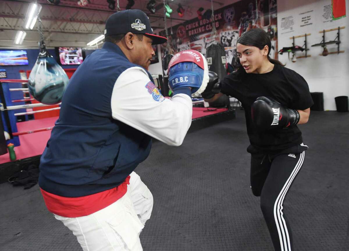 Brianna Alers, 16, of Hamden, trains with her coach Martin Chisholm at the Chick Rosnick Boxing Club in Stratford in December 2022. 