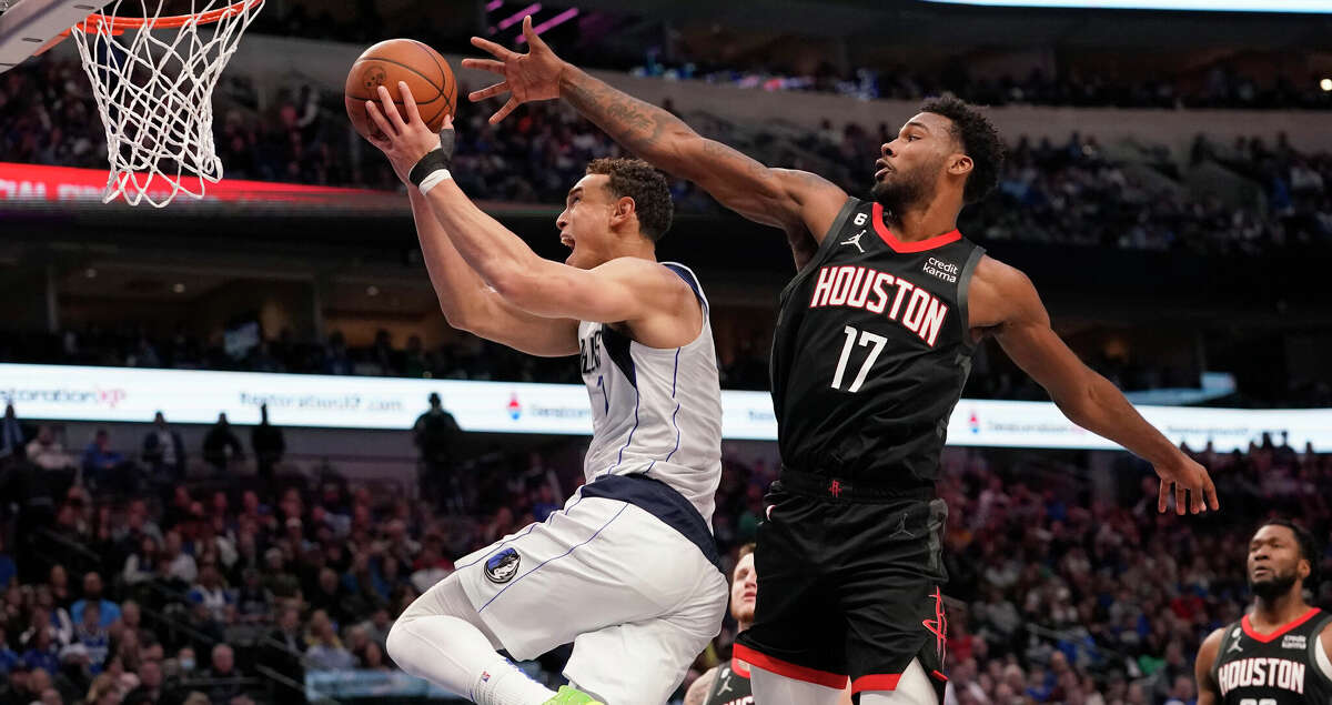 Dallas Mavericks center Dwight Powell, left, goes up to score a basket against Houston Rockets forward Tari Eason (17) during the first half of an NBA basketball game in Dallas, Thursday, Dec. 29, 2022. (AP Photo/LM Otero)