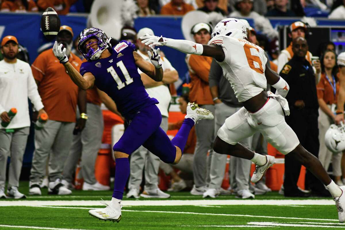Washington wide receiver Jalen McMillan (11) attempt to makes a catch during the second quarter of Friday’s Alamo Bowl game against Texas at the Alamo Dome.