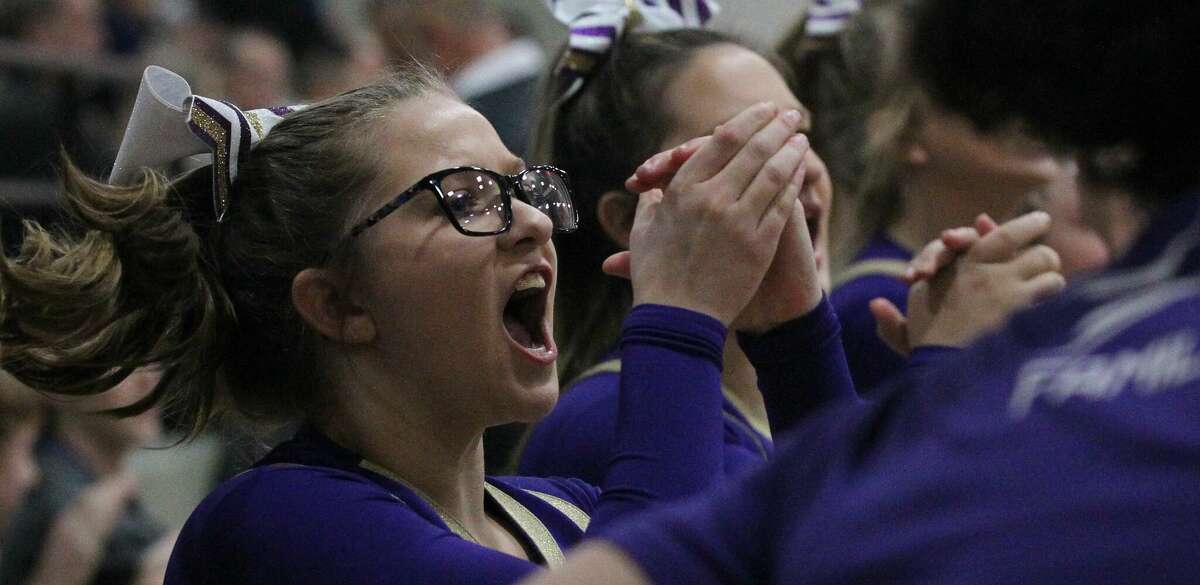 A Routt cheerleader cheers as the Rockets take the court for the championship game of the Waverly Holiday Tournament Thursday night in Waverly.