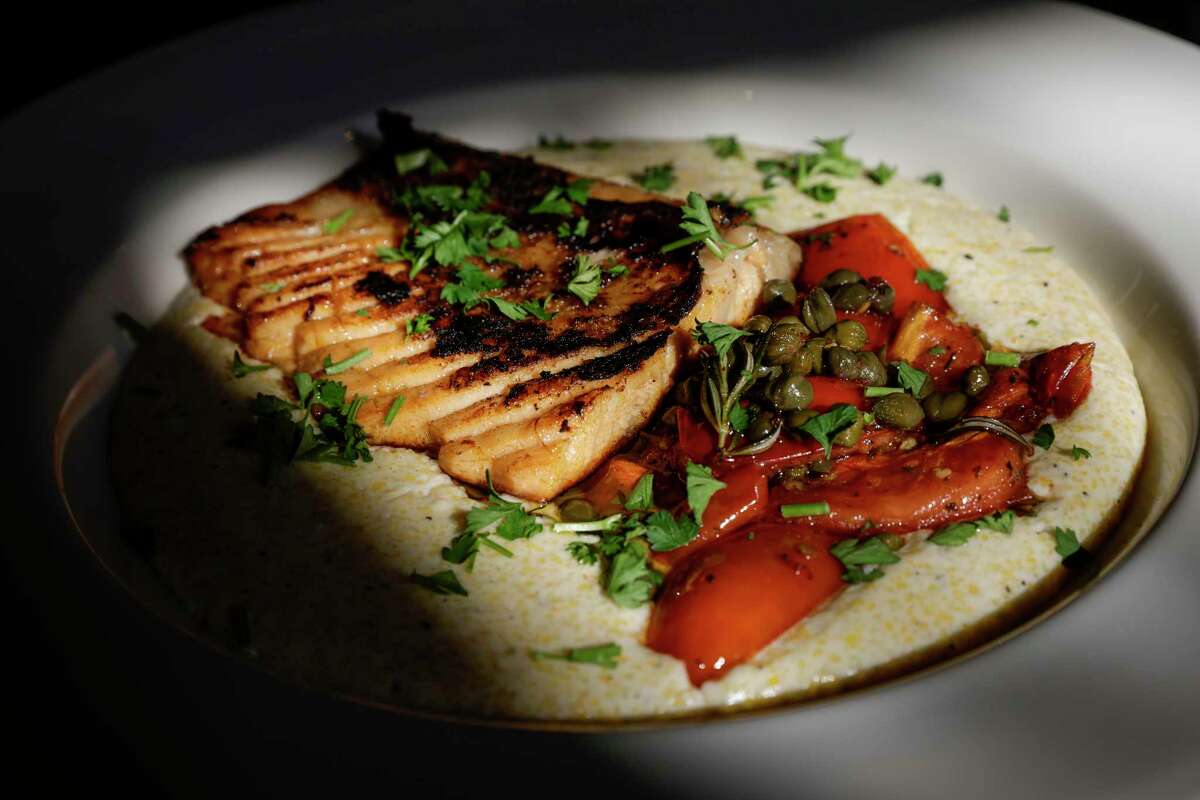 Smoked salmon belly, tomatoes and capers over polenta served at Calabash in Oakland.
