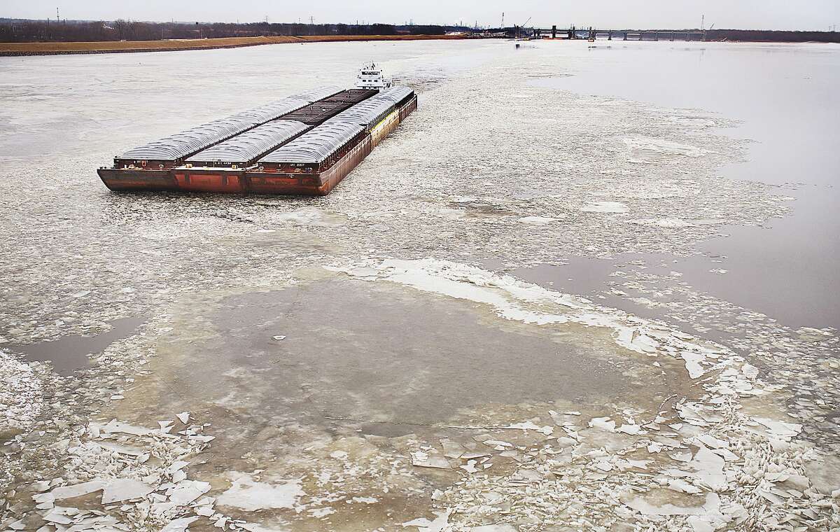 John Badman|The Telegraph A towboat pushes up river Friday through the ice starting to gather on Alton Lake. It will take a sustained patch of cold weather before the ice will hamper river traffic in any meaningful way.