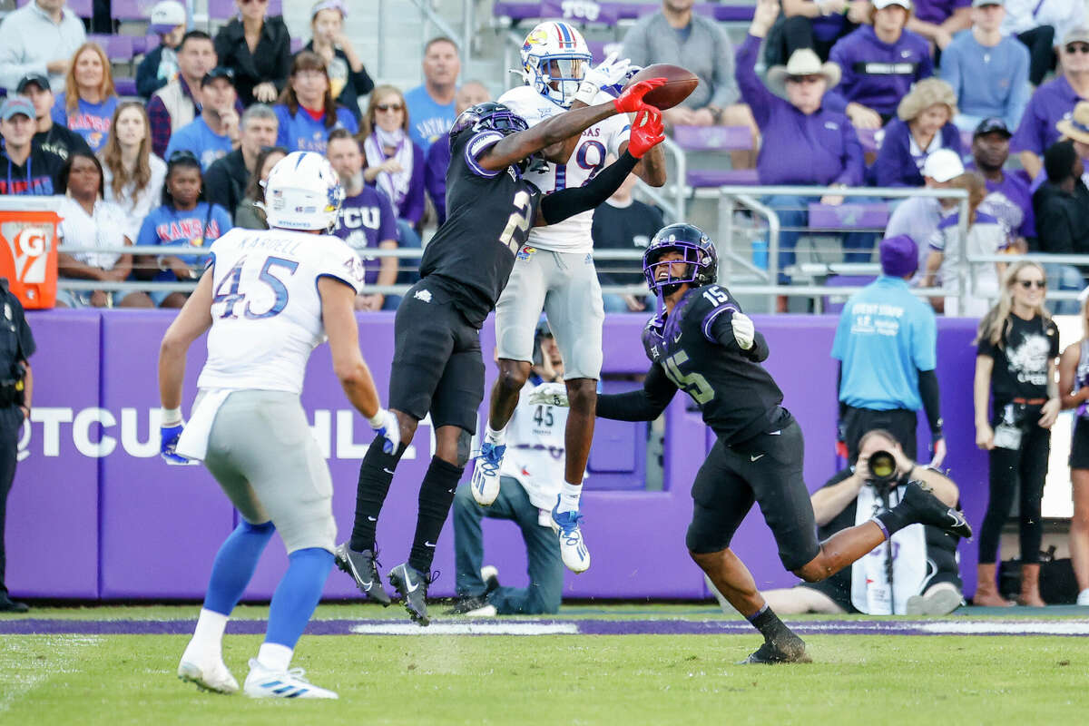 Kansas Jayhawks wide receiver Steven McBride (19) and TCU Horned Frogs cornerback Kee'Yon Stewart (2) battle for football at Amon G. Carter Stadium in Fort Worth on November 20, 2021.