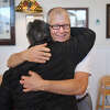 Julia's Bakery owner Jeffrey Chandler shares hugs with long time customers in the bakery's final week of their 32 year run in business, the last 9 years at 560 Boston Post Road, in Orange, Conn. on Thursday, December 29, 2022.