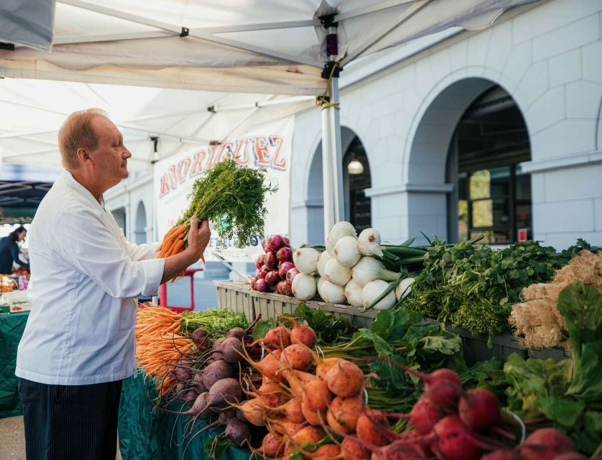 The Hyatt Regency chef Victor Litkewycz peruses the produce at the Ferry Building farmers market.