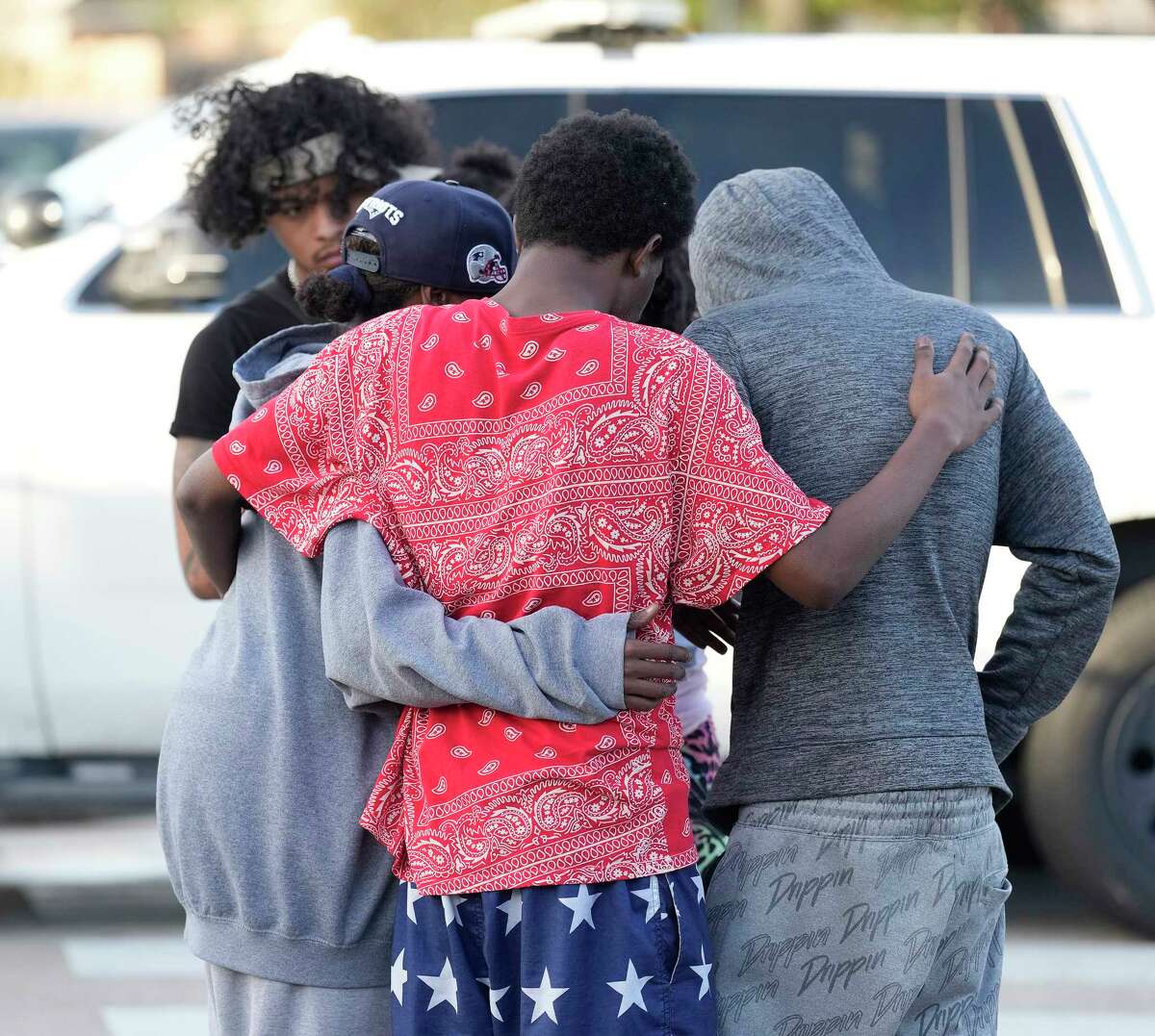 Tareka Lockhart’s family hugs each other after news of one of her son’s death after a shooting as Harris County Sheriff department investigated the scene where four people were shot and three killed at 4800 Park Square Lane on Friday, Dec. 30, 2022 in Humble.