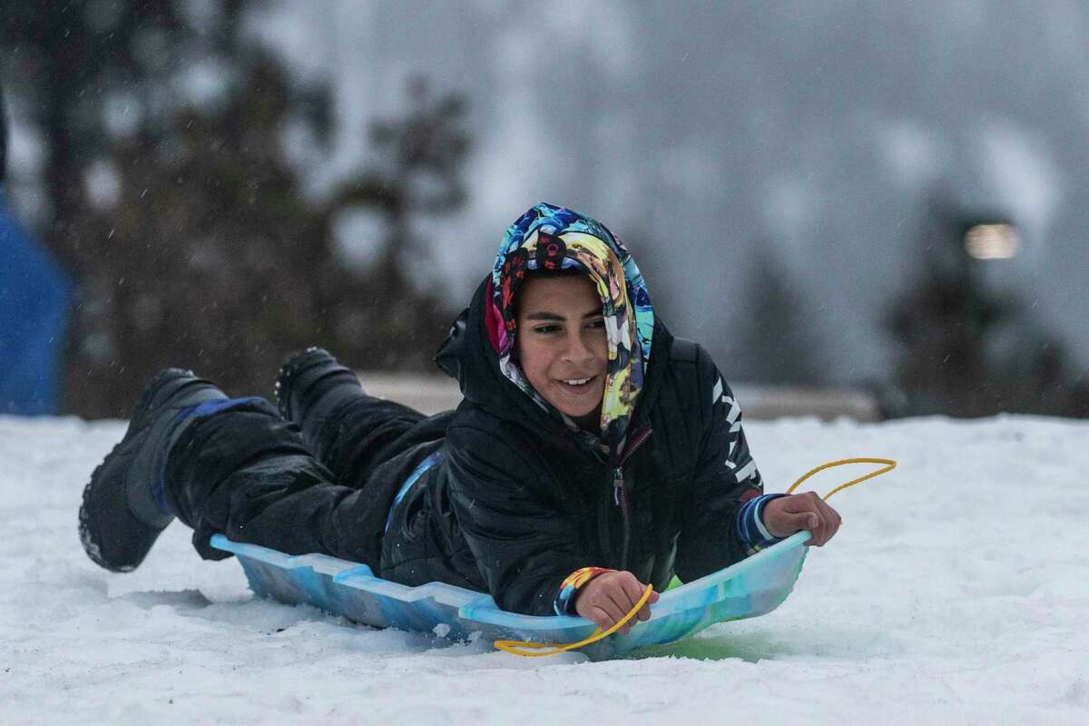 Josue Hernandez smiles as he sleds at Lake Tahoe Harbor in South Lake Tahoe.