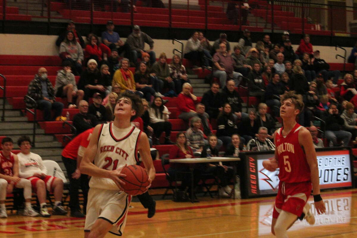Reed City's Ty Kailing goes to the basket in the second quarter for a layup after making a steal against Holton.