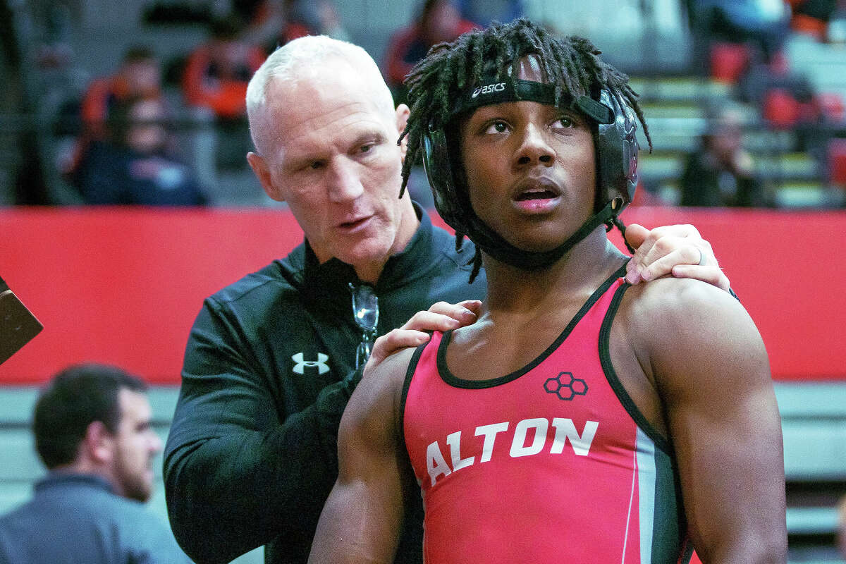 Alton 126-pound wrestler William Harris receives instructions from  coach Eric Roberson during the Red Schmitt Holiday Wrestling Tournament in Granite City. Harris is one of six seniors who will graduate off the team.