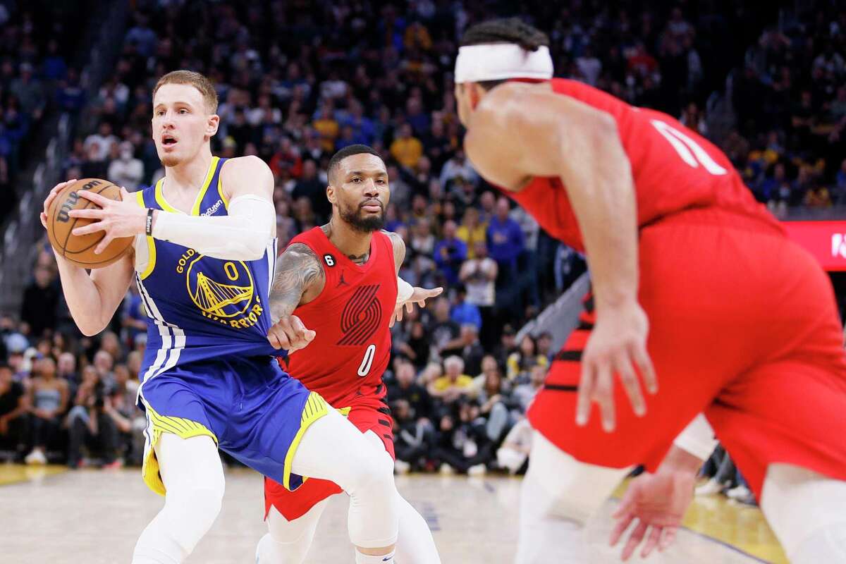 Golden State Warriors guard Donte DiVincenzo (0) steals the ball from Portland Trail Blazers guard Damian Lillard (0) with 40 seconds left in the fourth quarter during an NBA game at Chase Center in San Francisco, Calif., Friday, Dec. 30, 2022. The Warriors won 118-112.