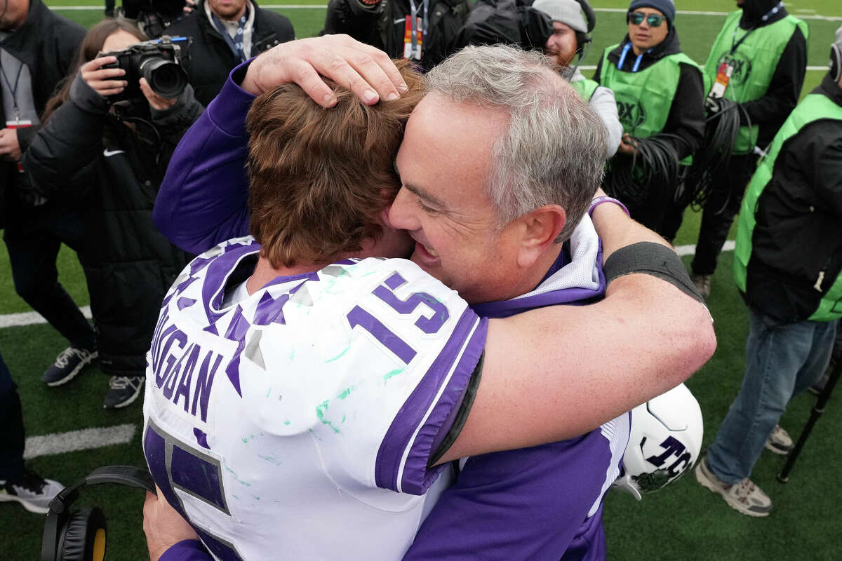 FILE - TCU head coach Sonny Dykes, right, hugs quarterback Max Duggan (15) after an NCAA college football game against Bayor in Waco, Texas, on Nov. 19, 2022. Duggan has thrown for 3,321 yards with 30 touchdowns and only four interceptions, and run for 404 yards with six more scores, heading into the Fiesta Bowl on Dec. 31. (AP Photo/LM Otero, File.