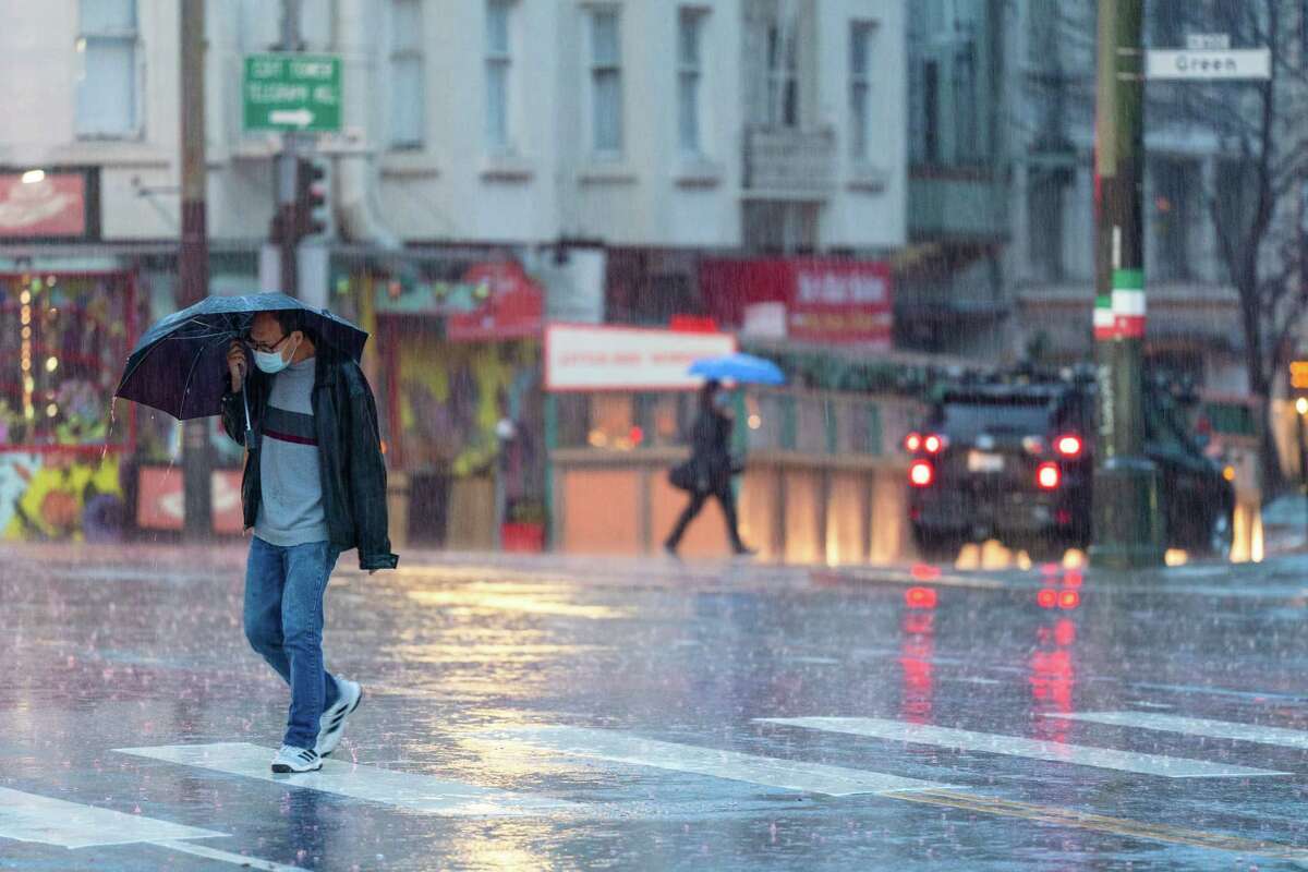 Pedestrians with umbrellas transverse  streets astatine  Columbus Avenue and Stockton Street successful  San Francisco connected  Saturday.