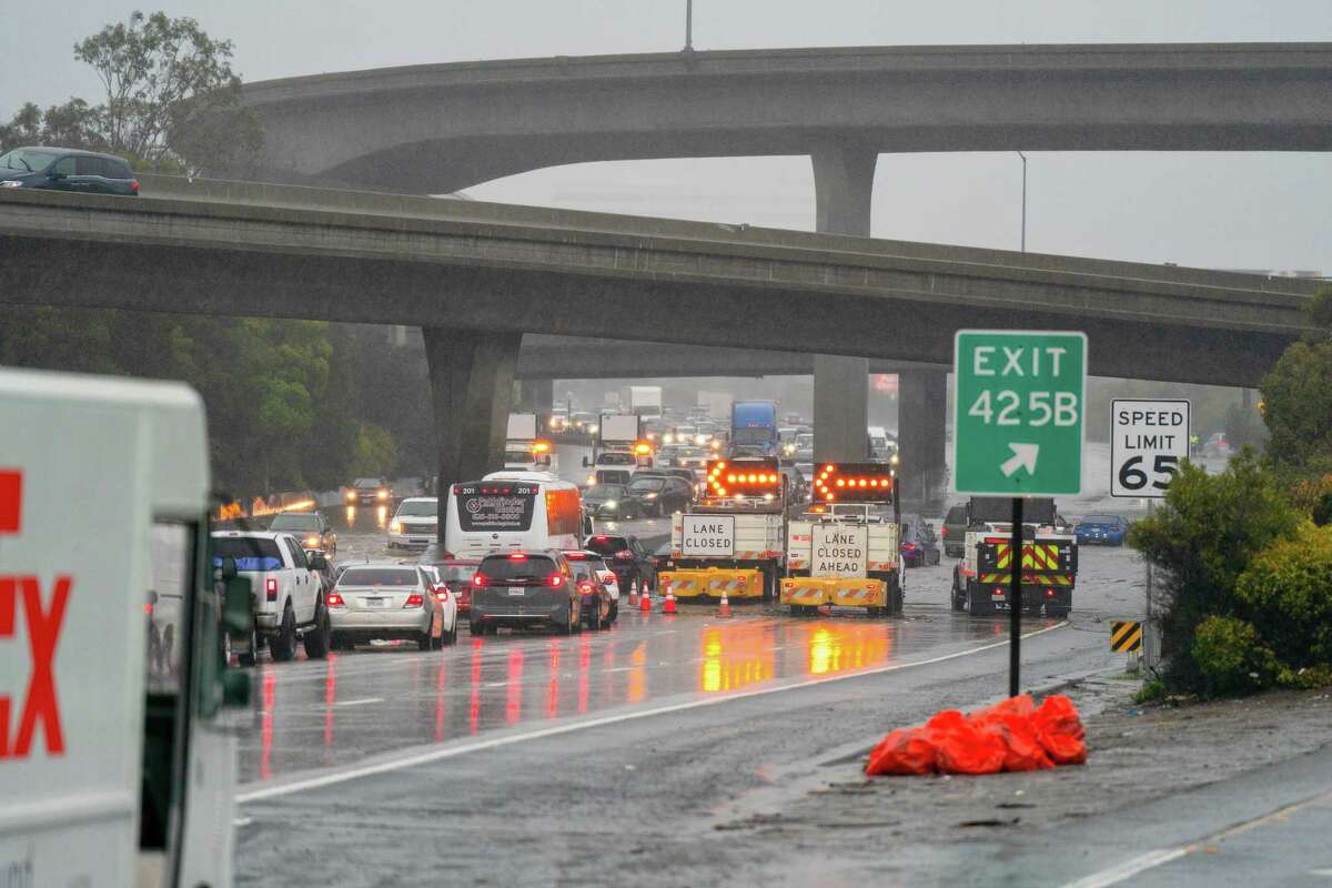 CHP and CalTrans block off multiple lanes as flooding gets as high as three feet along the Southbound 101 in South San Francisco on Saturday.