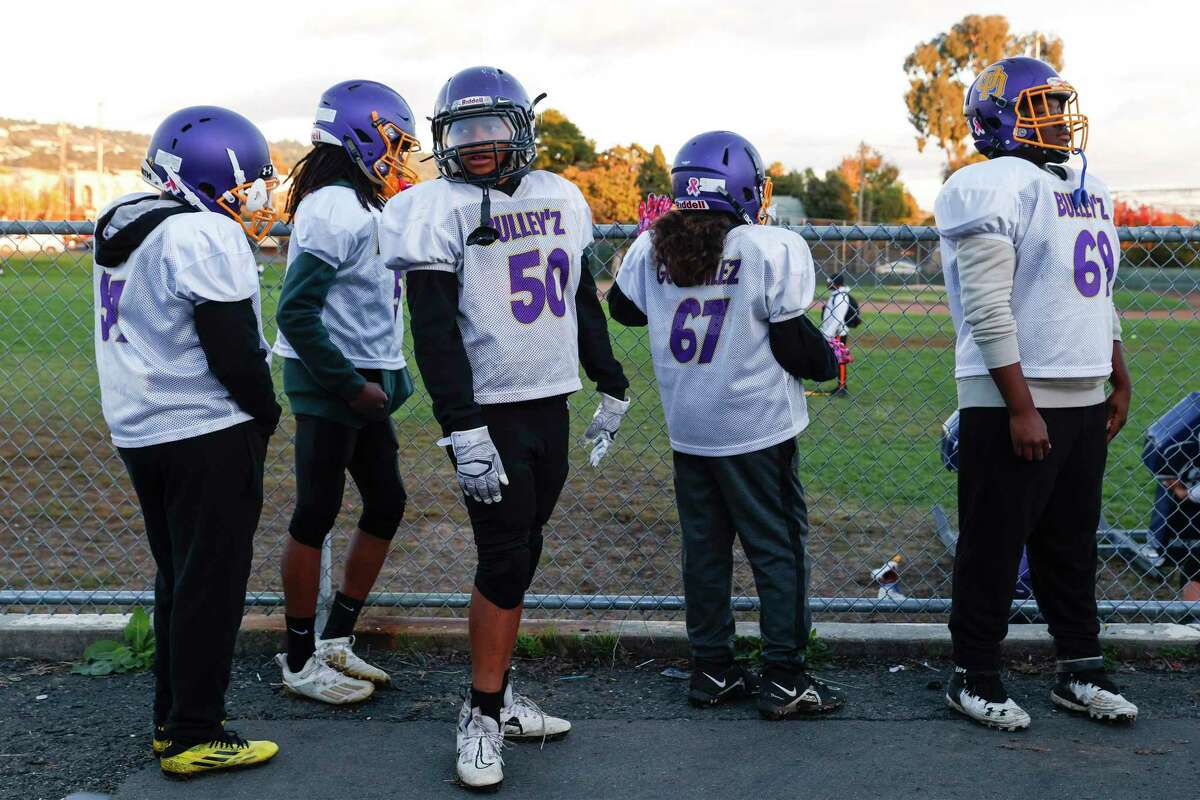 Lileiti Grew’s son Donta McNack (No. 50) lines up to do drills with his team the Oakland Dynamites in Oakland.
