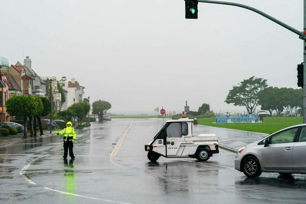 San Francisco Parking Enforcement block-off Marina Boulevard astatine  Buchanan Street owed  to flooding successful  the Marina successful  San Francisco, Calif. connected  Saturday, December 31, 2022.