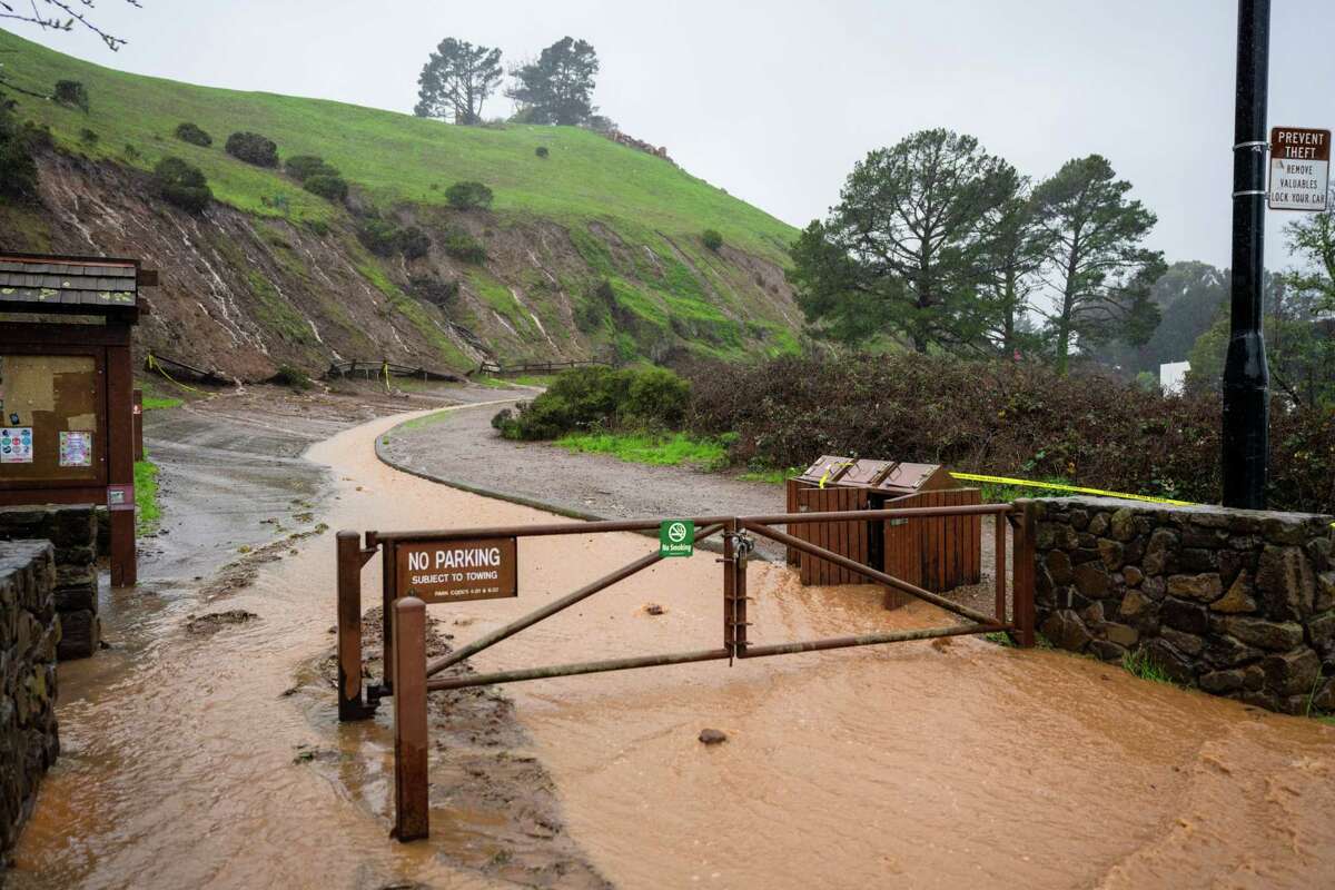 Soil and water flow down the road at Bernal Heights Park along Bernal Heights Boulevard in Bernal Heights, San Francisco, California on Saturday, December 31, 2022.