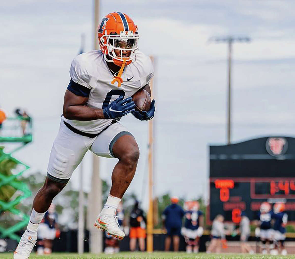 Illinois running back Josh McCray carries the ball during a team workout Saturday at the University of Tampa. The Illini are preparing to face Mississippi State on Monday in the Reliaquest Bowl in Tampa.