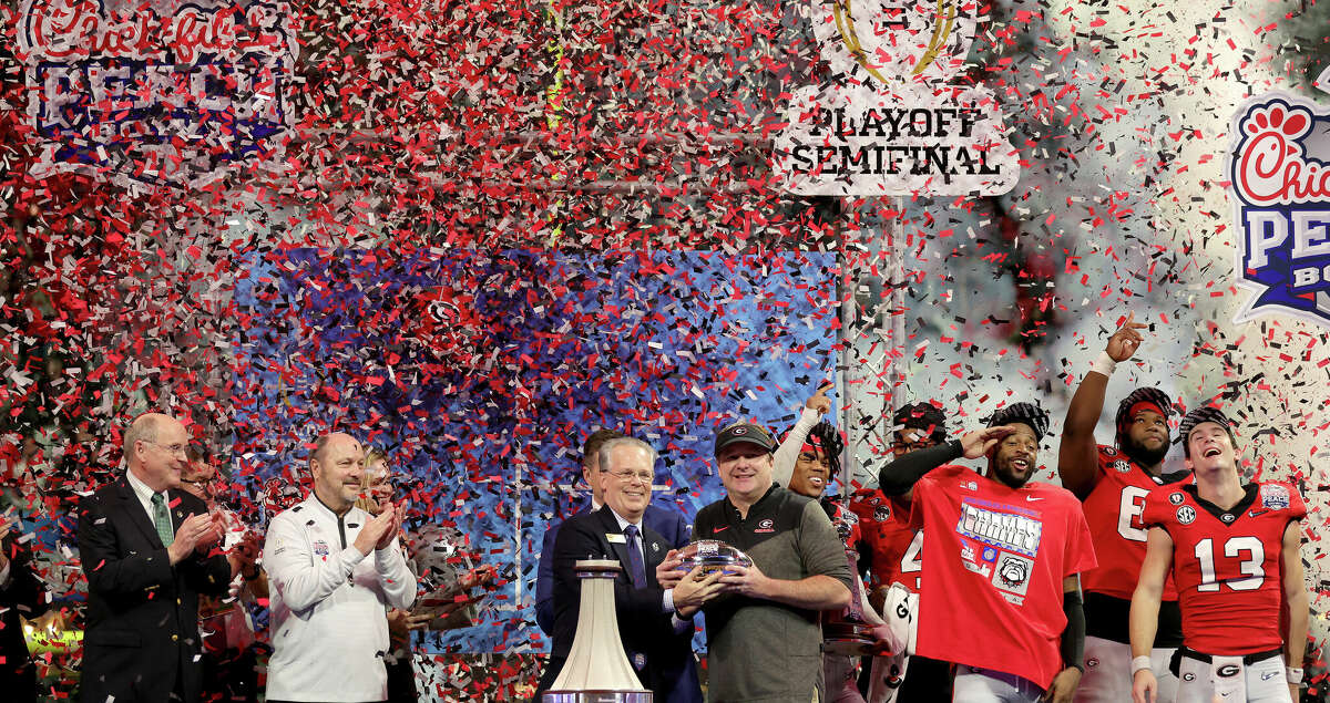 Head coach Kirby Smart of the Georgia Bulldogs celebrates with the trophy after defeating the Ohio State Buckeyes in the Chick-fil-A Peach Bowl at Mercedes-Benz Stadium on December 31, 2022 in Atlanta, Georgia. (Photo by Carmen Mandato/Getty Images)