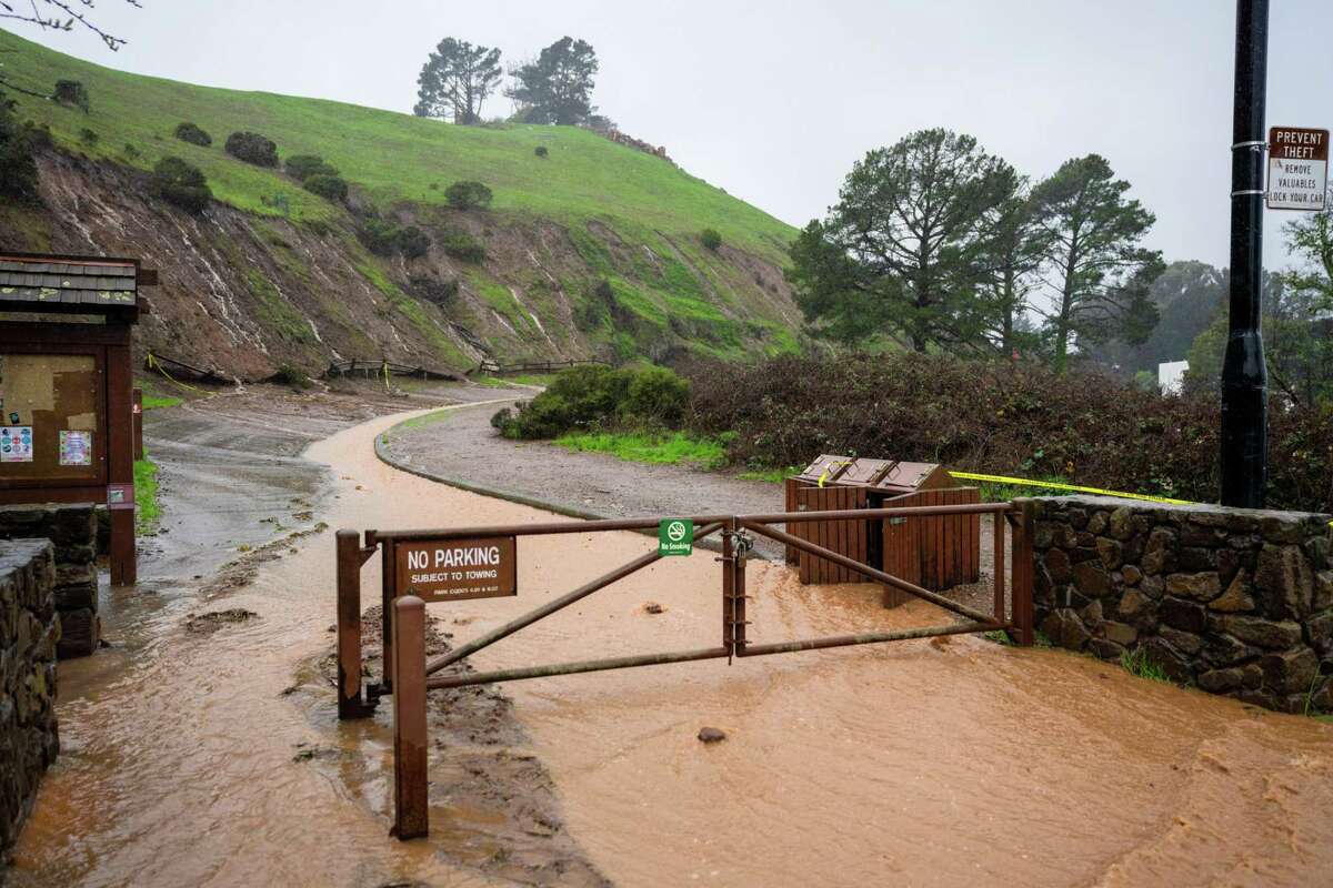 Mud and water flow down the road in Bernal Heights Park along Bernal Heights Avenue in San Francisco.